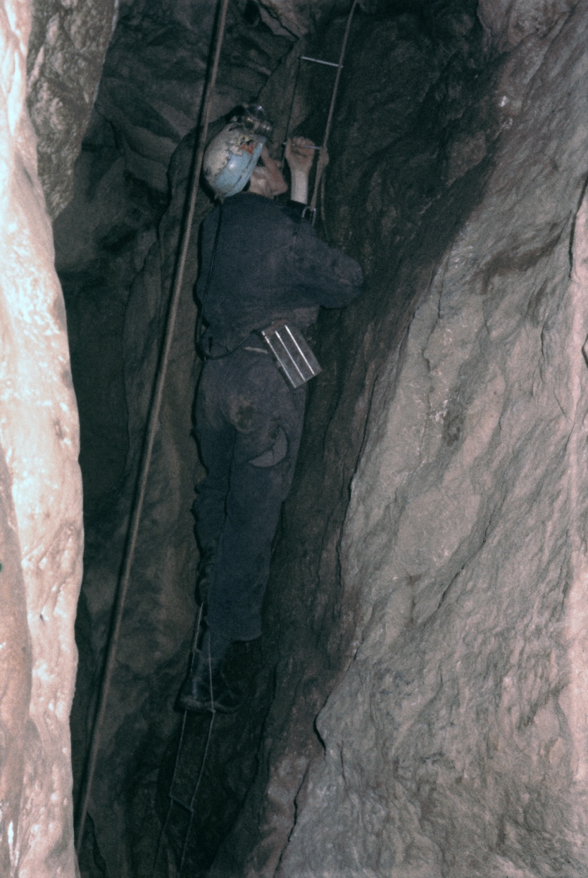 David Higginson climbing a pitch in Pixie’s Hole Chudleigh. Note the Edison lamp on his waist. 5th January 1969.