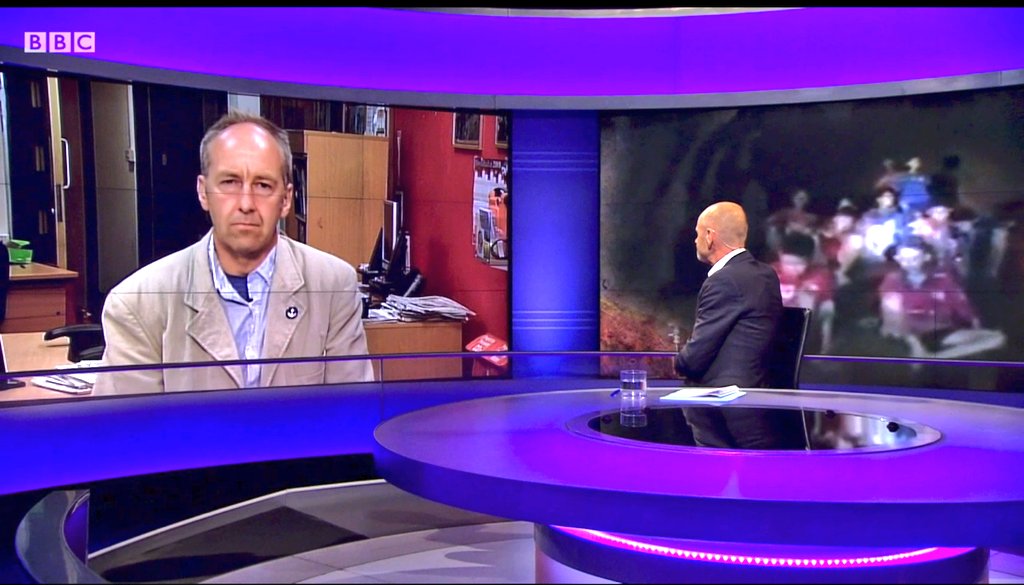 Peter Dennis, chairman of the British Cave Rescue Council, is interviewed on BBC’s Newsnight by Evan Davis, with John Volanthen’s images of the stranded boys in the background.
